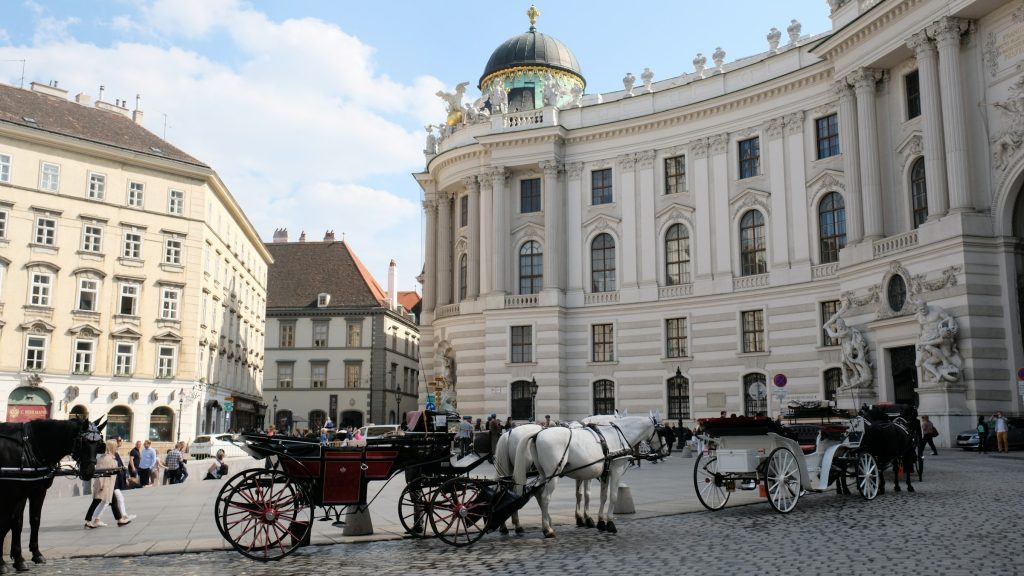 Horse carriages near a historic Vienna landmark