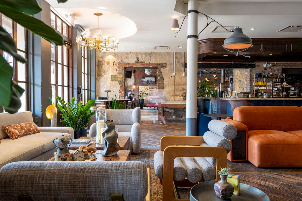 Industrial-style hotel lounge with exposed brick and modern furniture