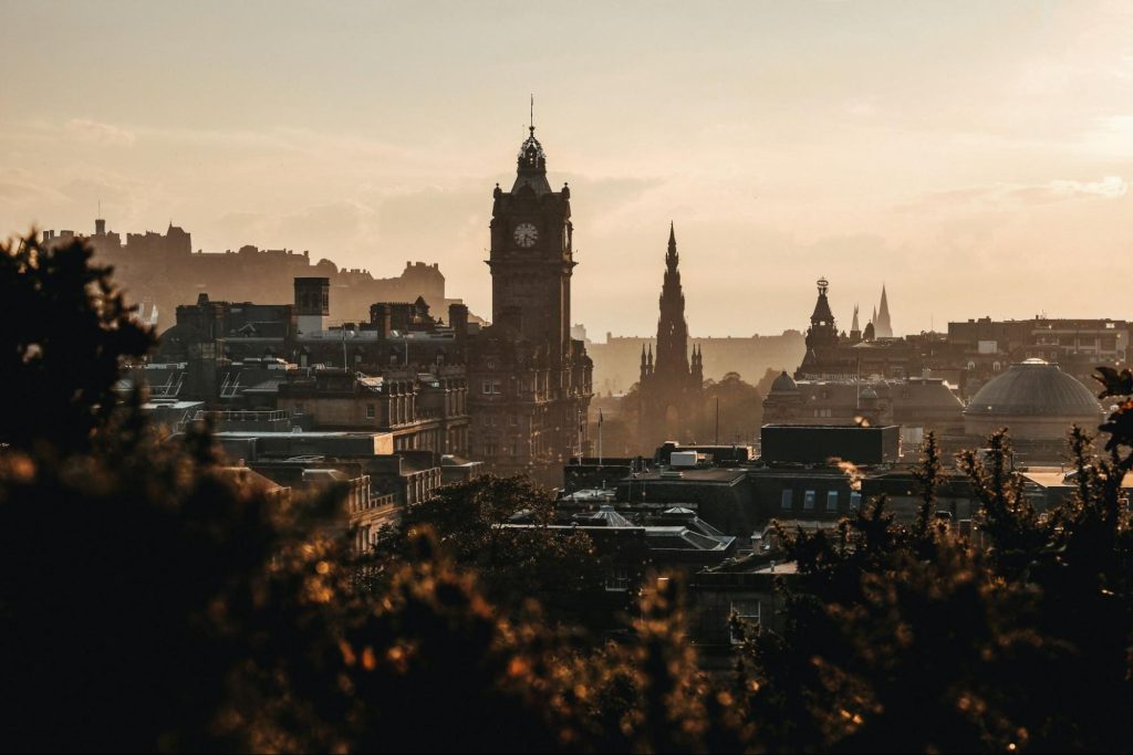 Edinburgh skyline at sunset with Balmoral clock tower and Scott Monument