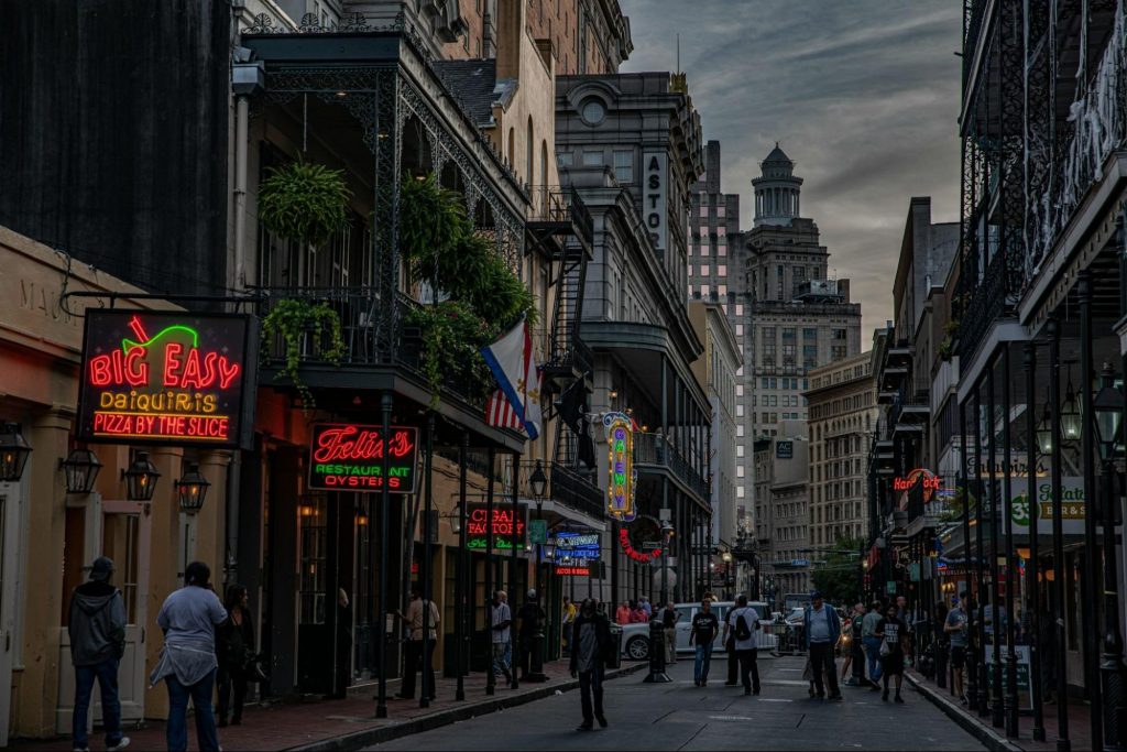 French Quarter street with historic buildings and neon signs