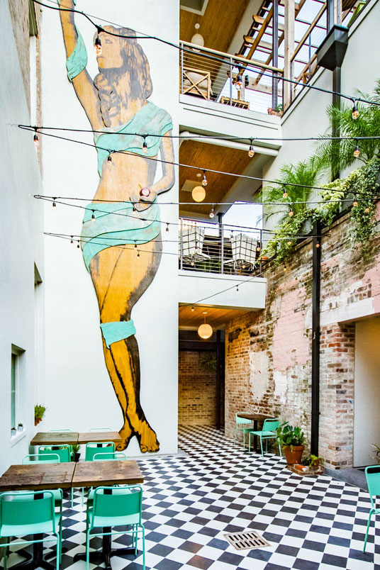 Courtyard mural and seating at The Catahoula Hotel