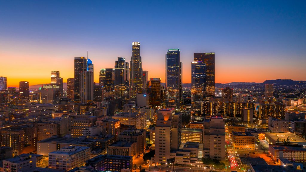 Downtown Los Angeles skyline at sunset with illuminated skyscrapers