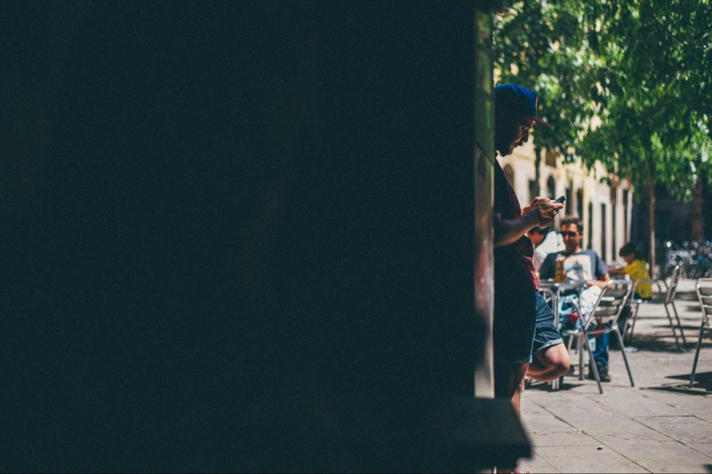 Traveler checking phone in Spanish city street