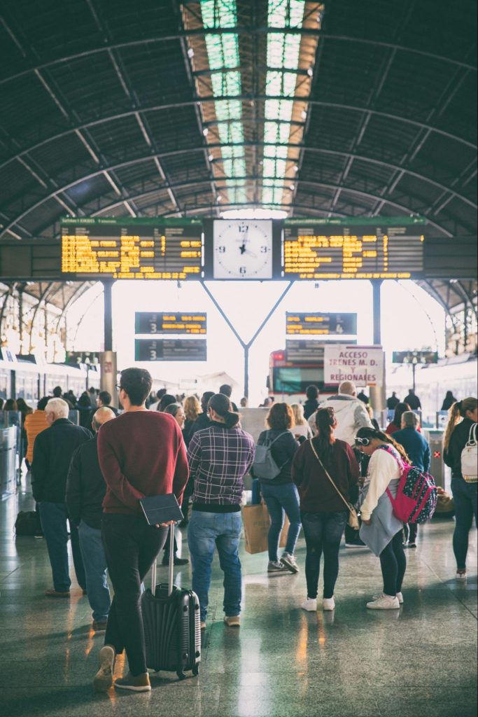 Passengers waiting at a busy Spanish train station