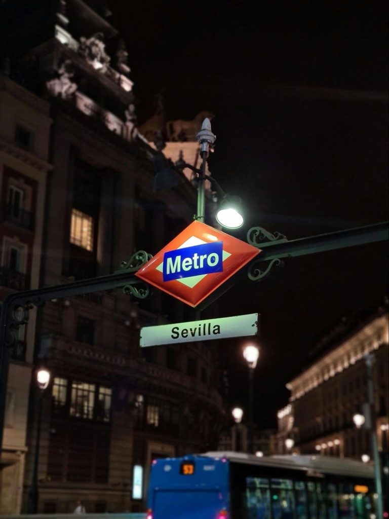 Sevilla metro sign at night in Madrid, Spain