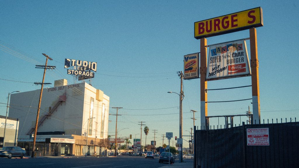 North Hollywood street with local burger sign and palm trees