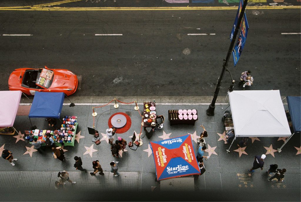 Hollywood Walk of Fame street view with tourists and star plaques